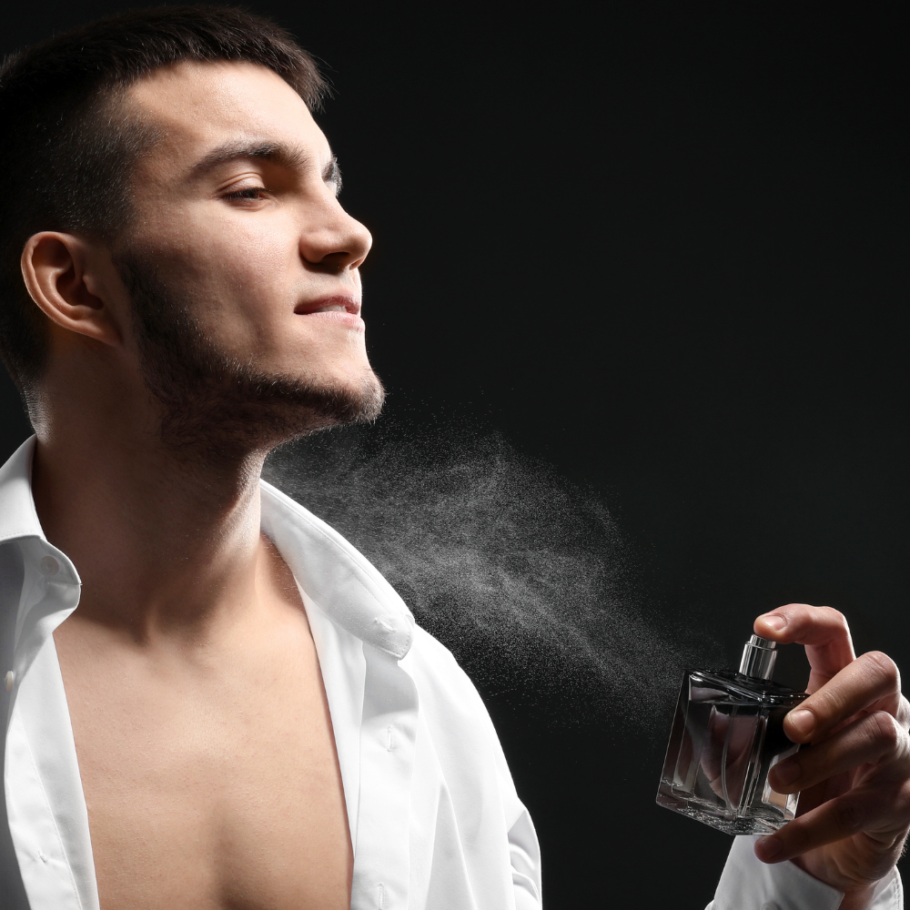 man spraying cologne