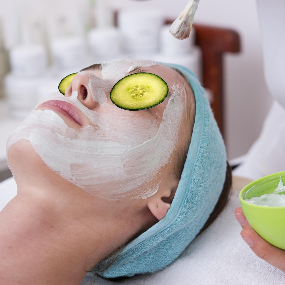 woman getting a facial mask at the spa