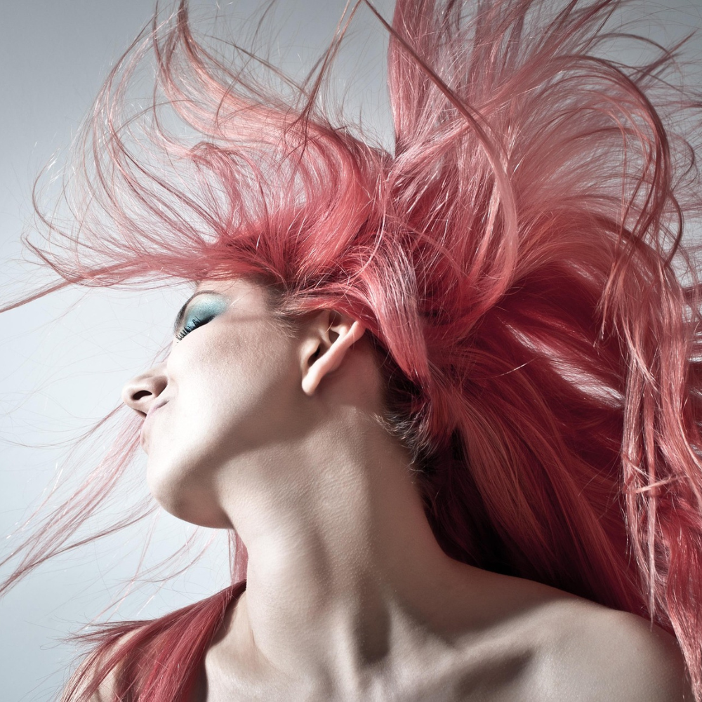 woman flipping her illustrious hair into the air